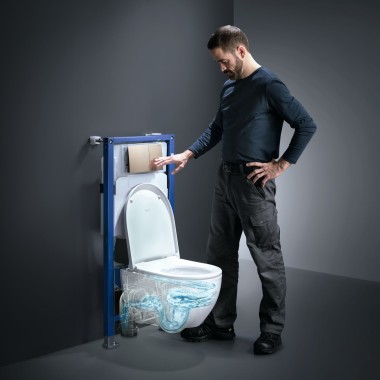 Un uomo aziona la tecnologia TurboFlush di una toilette Geberit Acanto
