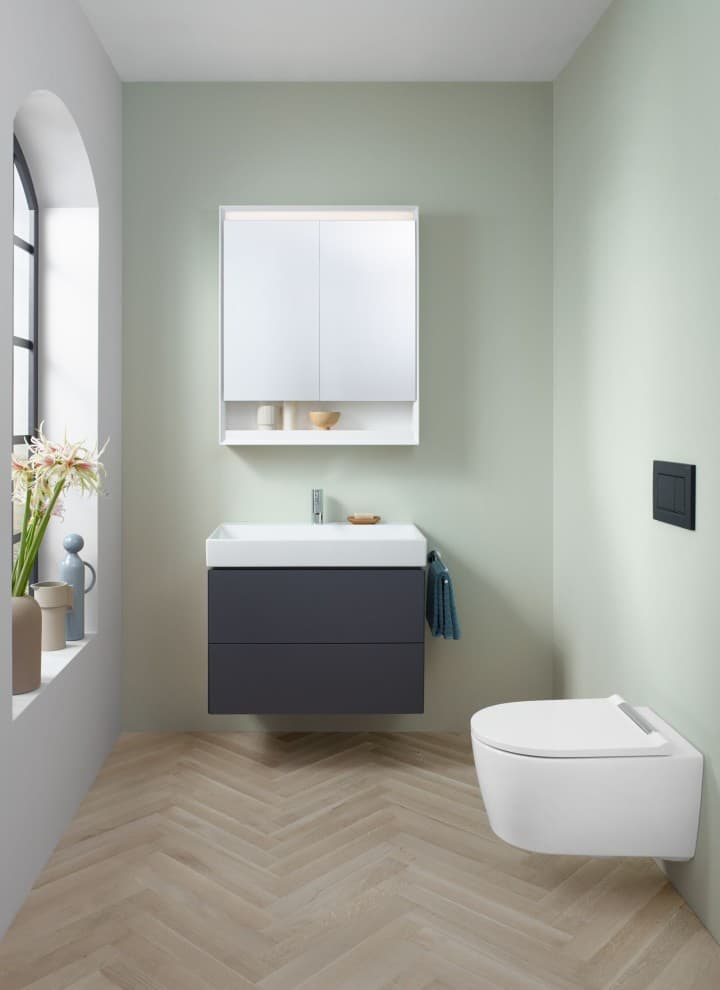 Vista di un bagno ospiti con vaso WC sospeso, specchio contenitore e mobile sottolavabo della serie Geberit ONE Vista di un bagno ospiti con vaso WC sospeso, specchio contenitore e mobile sottolavabo della serie Geberit ONE